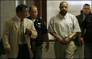 Chris Cathcart leaves the courtroom in shackles.