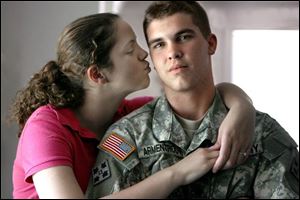 Spec. Cory Armentrout, 19, home in Fremont while on leave from Iraq, receives a kiss from fiancee Heather Singleton. The pair, who got engaged during his leave, now face his return to Iraq.
