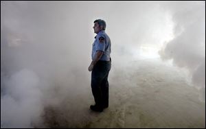 Lt. John Ciriello of the New York Fire Department, above, watches as smoke builds on the ground floor.