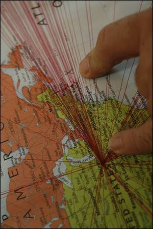 Steve Michalski demonstrates on a map the distance from Ohio to a distress call he heard.