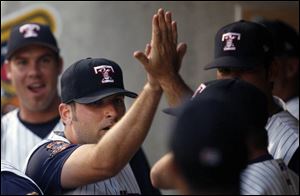 Mud Hens pitcher Steve Green is congratulated after helping to turn a triple play in the second game of the doubleheader.
