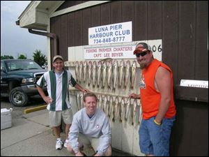Southview teachers Matt Fojtik, left, Steve Swaggerty and Terry Shadle show their limits of walleye after a Lake Erie trolling trip on the boat of Lee Boyer, known as the Fishing Farmer. 
