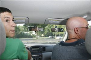 Ben Stalets keeps an eye on what's behind his car as he practices maneuvering in reverse with instructor Chris Gerdeman.