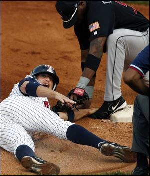 Toledo s Ryan Raburn slides under the tag of Indianapolis
third baseman Yurendell de Caster in last night s game.
