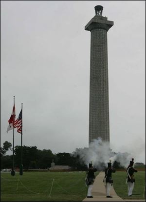 Members of the Perry s Memorial staff give the new Americans a musket salute.
