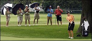 A group of fans keeps a close eye on Annika Sorenstam as she practices a shot from off the putting green yesterday at Highland Meadows Golf Club. Sorenstam will start on the 10th tee at 8:40 a.m. tomorrow along with Se Ri Pak and Paula Creamer.