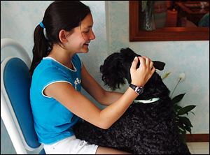 Shannon LaGassa, 12, shares a quiet moment with Cricket.