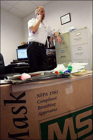 The screensaver on the computer in his cluttered office still says 