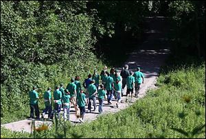Bernie Place of Wild Birds Unlimited guides Sylvania Youth Conservation Corps members on a walk through Harroun Park.