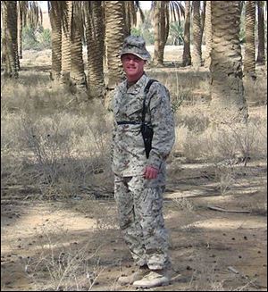 Chief Warrant Officer Ray Post of the 3rd Marine Aircraft Wing takes time out for a photograph while on a tour of duty in Iraq.