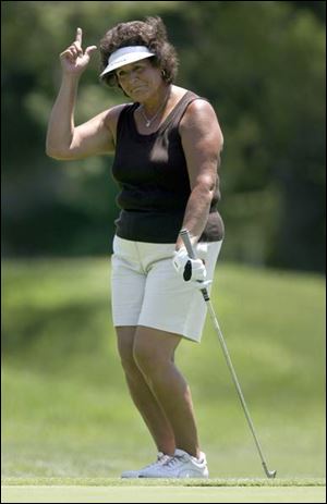 Hall of Famer Nancy Lopez does a little dance after chipping in for birdie on the 18th hole. She didn't make the cut, but that didn't matter as the crowd went crazy for the Farr Classic favorite.