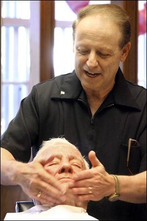 Tom Smith jokes with Clay Hepler, his last customer before retiring.