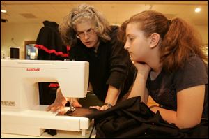Lynn Reaume, left, helps Hayli Shropshire work on a frock.