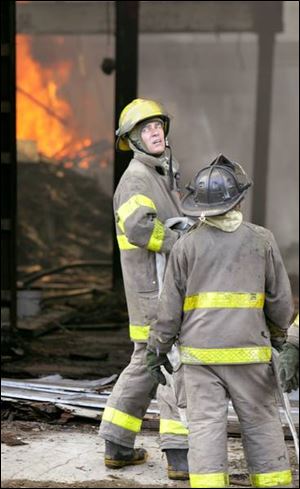 Firefighters await water to battle the blaze.