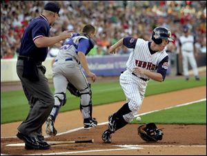 Toledo's Kevin Hooper heads for first base after Durham catcher Shawn Riggans couldn't hold on to a third strike. Hooper was thrown out at first. He had three of Toledo's 16 strikeouts.
