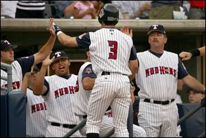 The Mud Hens' David Espinosa is greeted by his teammates after hitting a home run last night at Fifth Third Field.