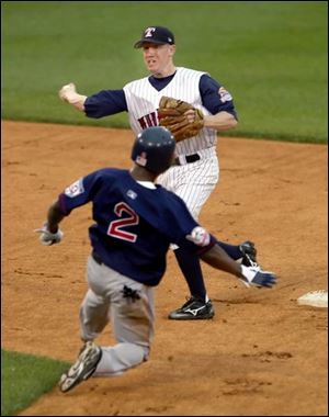 Hens second baseman Kevin Hooper turns a double play against Pawtucket last night at Fifth Third Field. Play was stopped shortly after 10 p.m. when thunder and lightning occurred.