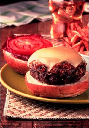 Deluxe Cheeseburger is topped with carmelized onions and Comte cheese.