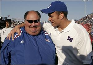 Mark Mangino, left, has adjusted the schedule to help get Kansas back in the win column.