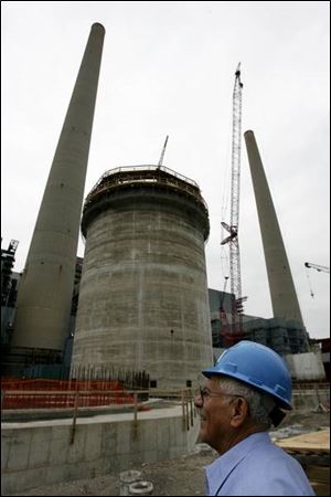 Frank Stray, site manager for the upgrade at Detroit Edison's coal-fired power plant in Monroe, supervises the work on a new smokestack. He said he helped build the original stacks in 1969 and came out of retirement for this project. 