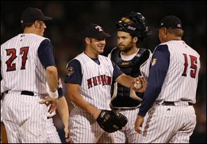 Hens manager Larry Parrish takes the ball from reliever Lance Davis, who was pulled in the sixth inning - one of two in which Rochester scored four runs. After a playoff run fueled by good pitching, the Hens gave up 10 runs last night.