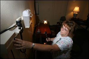 Nurse Marcia Young readies an examination room for today s opening of the Huron Street Women s Center. The center will offer more than just routine clinical services.
