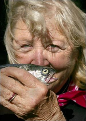 Recovering breast cancer patient Nancy May of Grand Rapids proudly shows off her trout.