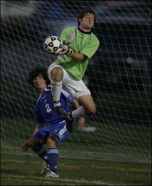 Anthony Wayne s Nick Smith watches his team s goalkeeper, Matt Muntz, make a save last night against Northview.