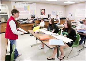 Michele Engel gives test to her physics class, including twins Lyndsay and Abby Osterhout, who are 17.
