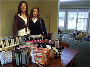Kathy Losey, left, and Kelli Harshman are able to keep an eye on their combined six boys at the same time they run their bag-making enterprise. 