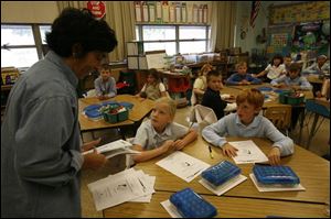 Sylvia Washborn discusses facets of the state achievement tests her third-grade students will be taking this week at Beverly Elementary School in South Toledo. Ohio students are taking five more exams this year because of requirements under the federal No Child Left Behind Act.