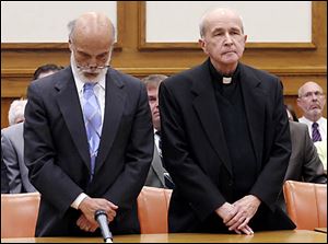 Defense attorney Alan Konop, left, hangs his head as the Rev. Gerald Robinson is found guilty on May 11 of the 1980 murder of Sister Margaret Ann Pahl.
