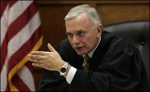 Judge Thomas Osowik, left, of Lucas County Common Pleas Court, is seeking 12 'fair and impartial' jurors and four alternates for the case, which resumes today.
