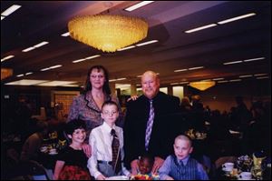 Melinda and Clark Trowbridge with children Amber, 9, Derreck, 11, Deon, 2, and Jared, 7, at the Adopt America benefi t.
