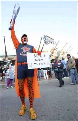 Dan Novack of Redford, Mich., tries to pump up the arriving fans.