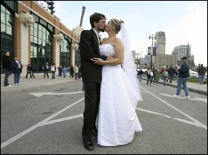 Mark Chapin and Carolyn Stock-Chapin share a kiss at Comerica Park before the game.