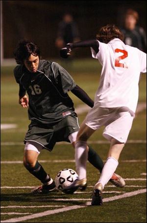 Ottawa Hills' Jordan Bernardo, left, and Mansfield Christian's Josh Morich try to control the ball. Bernardo scored a goal.