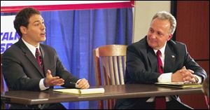 Ben Konop, left, makes a point as rival George Sarantou listens during the debate at the McMaster Center downtown.