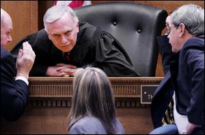 Judge Thomas Osowik of Lucas County Common Pleas Court, right, pauses to consider a point in the Noe proceedings. Testimony is slated to resume today.