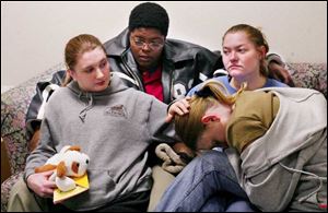 Relatives are seeking justice for a 40-year-old Decatur, Ill., woman who was assaulted near the Greenbelt Parkway. From left are the victim's daughter, Nichole; niece, Verneal Ludy; niece Krystal Ludy, and daughter, Keirsten, as they sit in a waiting room at St. Vincent Mercy Medical Center.