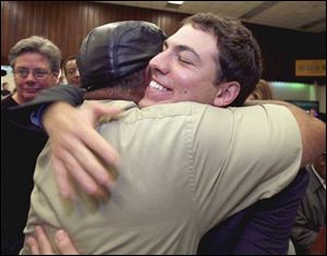Ben Konop, right, is hugged by supporter Harold Stevens at the UAW Local 12 hall as the unof-
fi cial election results showed Mr. Konop had won the race for Lucas County commissioner.