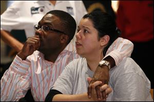 Valentine Ononye and his fi ancee, Betsy Beredo, a COSI employee, watch early returns for Issue
11, a 0.167-mill levy for the children s science center in downtown Toledo.