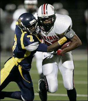 Whitmer's Apollo Scott stops Canton McKinley's Morgan Williams on this play, but Williams wasn't stopped often.