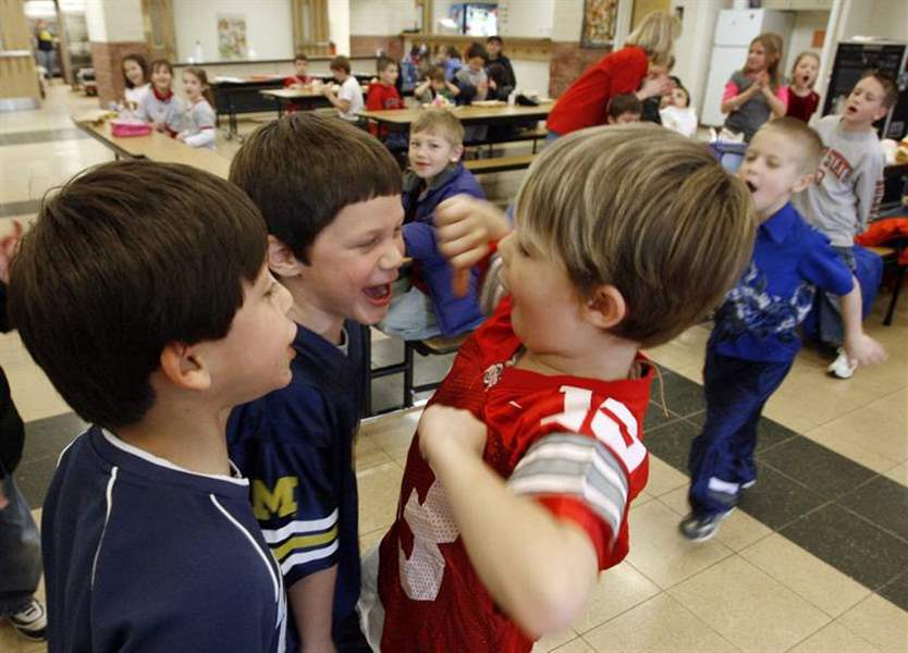 Area-schoolkids-warm-up-for-a-gridiron-collision