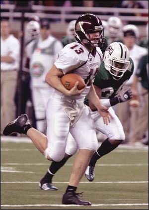 Central Michigan quarterback Dan LeFevour sprints past Ohio
defender Michael Mitchell in the MAC championship game.
