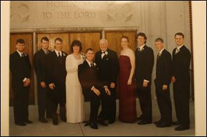 Benjamin Tipping, second from right, will join his six brothers in the distinction of being an Eagle Scout tonight. From left are brothers Joseph, Daniel, and Edmumd; mother, Irene; brother Jeremiah; father, Gary; sister, Andrea, and brother Peter. At far right is Benjamin s brother Matthew. A foster brother, Benjamin Jackson, not pictured, also is an Eagle Scout.