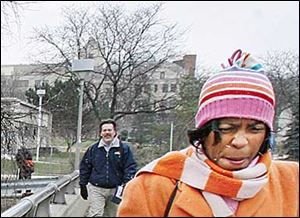 Tracci Harmon, director of student activities and leadership, braces against the cold weather on the University of Toledo campus today.