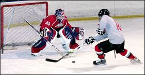Bedford junior goaltender Lucas Fournier guards the net against Garryt Kujawa during practice. 
