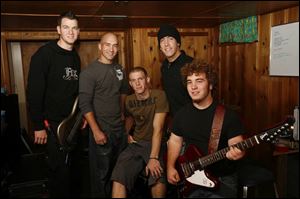 Members of the Christian rock band Pawn   from left, Robert Golden, Travis Montgomery, Kyle Kleeberger, Mark Montgomery, and Tim Strausbaugh   get together for a practice session.