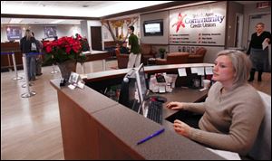 Rae Koppelman greets customers at the credit union that began in 1953 with 123 members and $10,231 in assets.